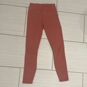 XXS auburn leggings, with cross knit phone holder on back.